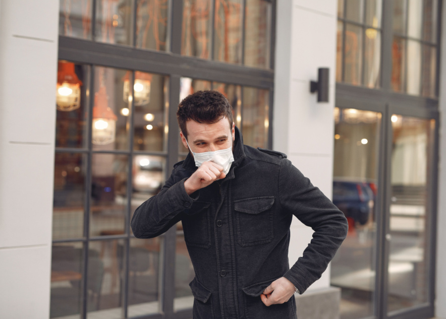 Man in a mask coughing and sneezing | Haze in Singapore