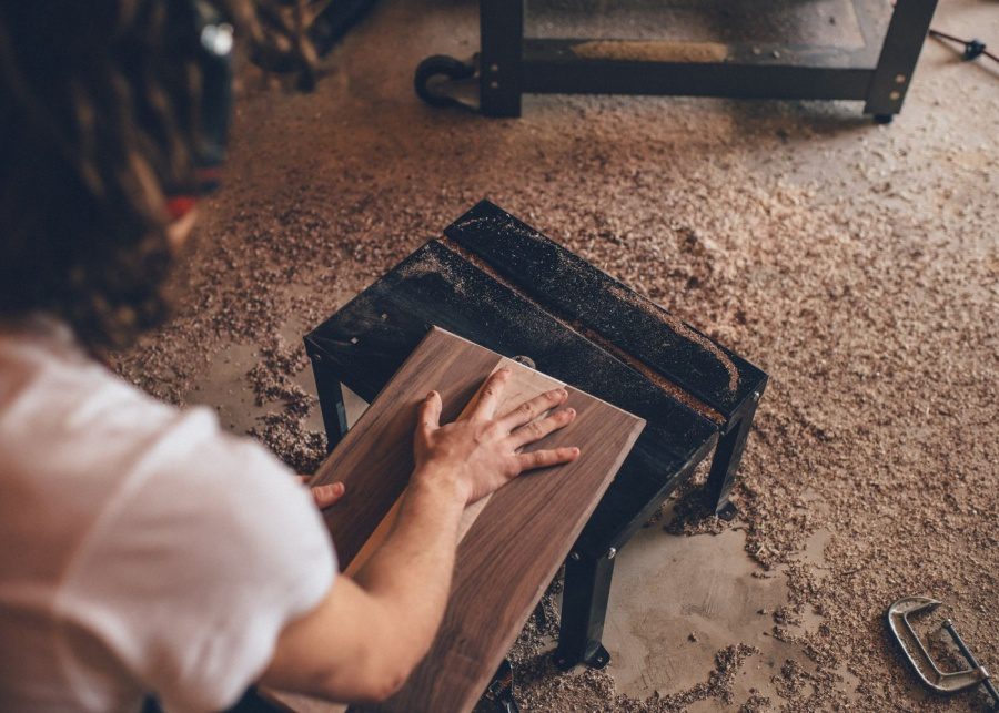 person touching brown plank | carpenters singapore