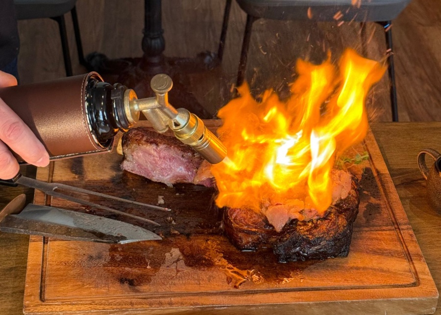 Tomahawk contemporary steakhouse knife on fire