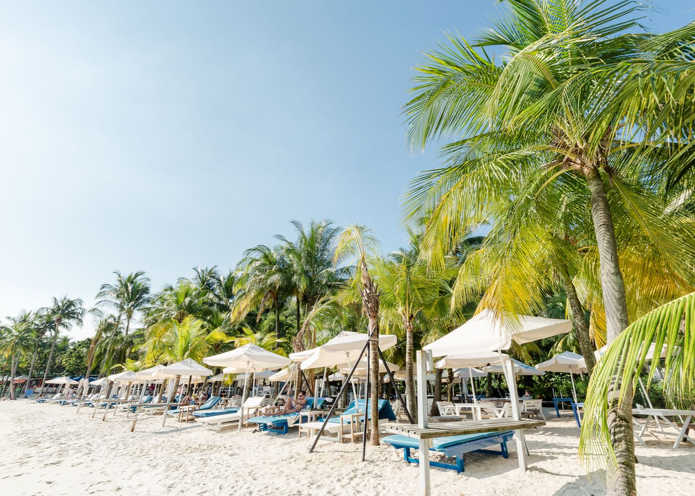 a picture of Singapore beach with beach beds