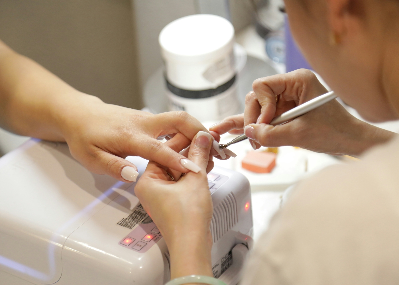 Best nail salons in Singapore - Close-up of a beautician doing a manicure