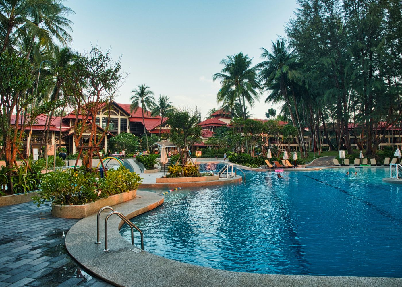best-hotels-staycations-singapore-outdoor-swimming-pool-surrounded-by-green-trees