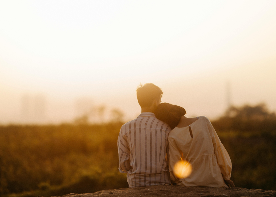 asian couple looking at sunset