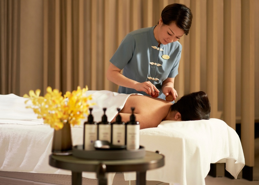 Best spas in Singapore - Raffles Spa therapist giving a back massage to a customer