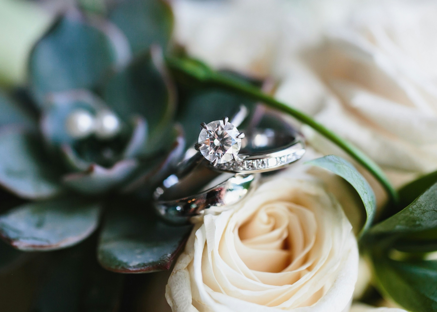 Best engagement rings in Singapore - A sparkling diamond ring nestled among white roses