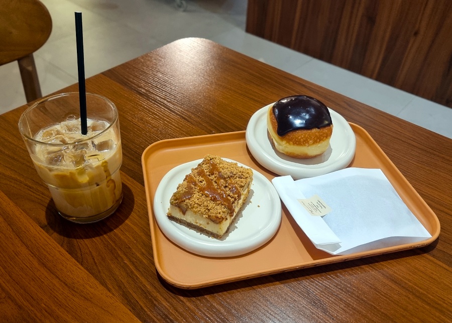 Puff and Peaks' iced honey latte, apple crumble salted caramel mascarpone cheesecake, and Boston cream doughnut | New cafes in Singapore 2025