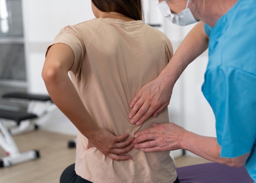 Oxford Spine and Neurosurgery Centre - Back pain - Medical assistant doing physiotherapy exercises with client