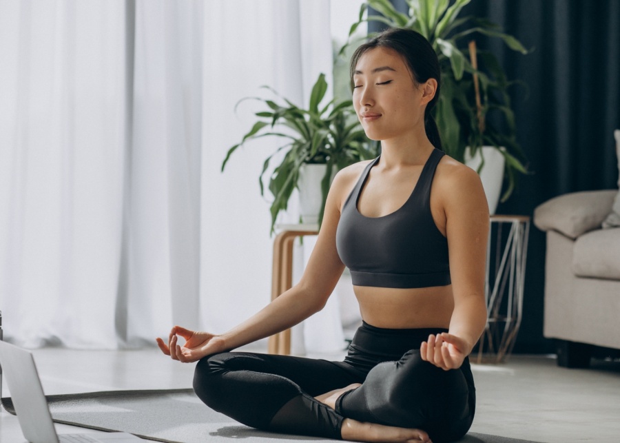Lunch break activities - Woman meditating on a yoga mat