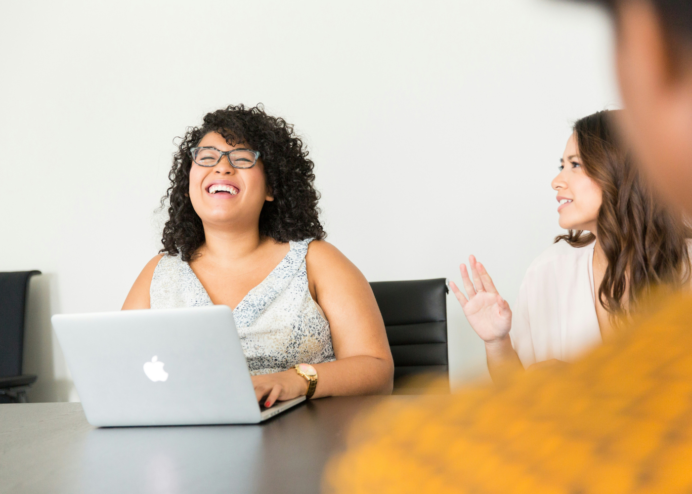 woman with laptop laughing