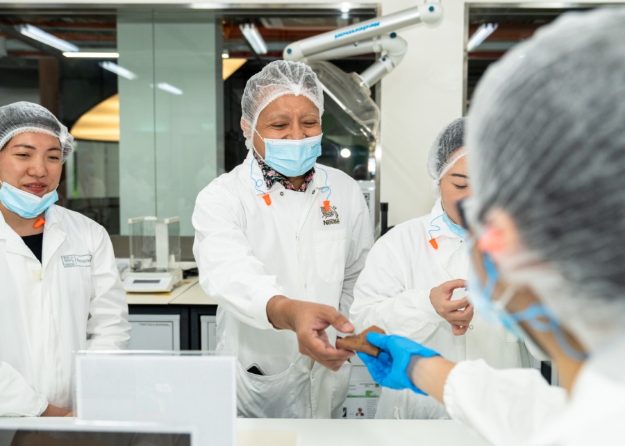 The author trying freshly baked Milo wafers out of the oven | Celebrating 75 years of Milo in Singapore