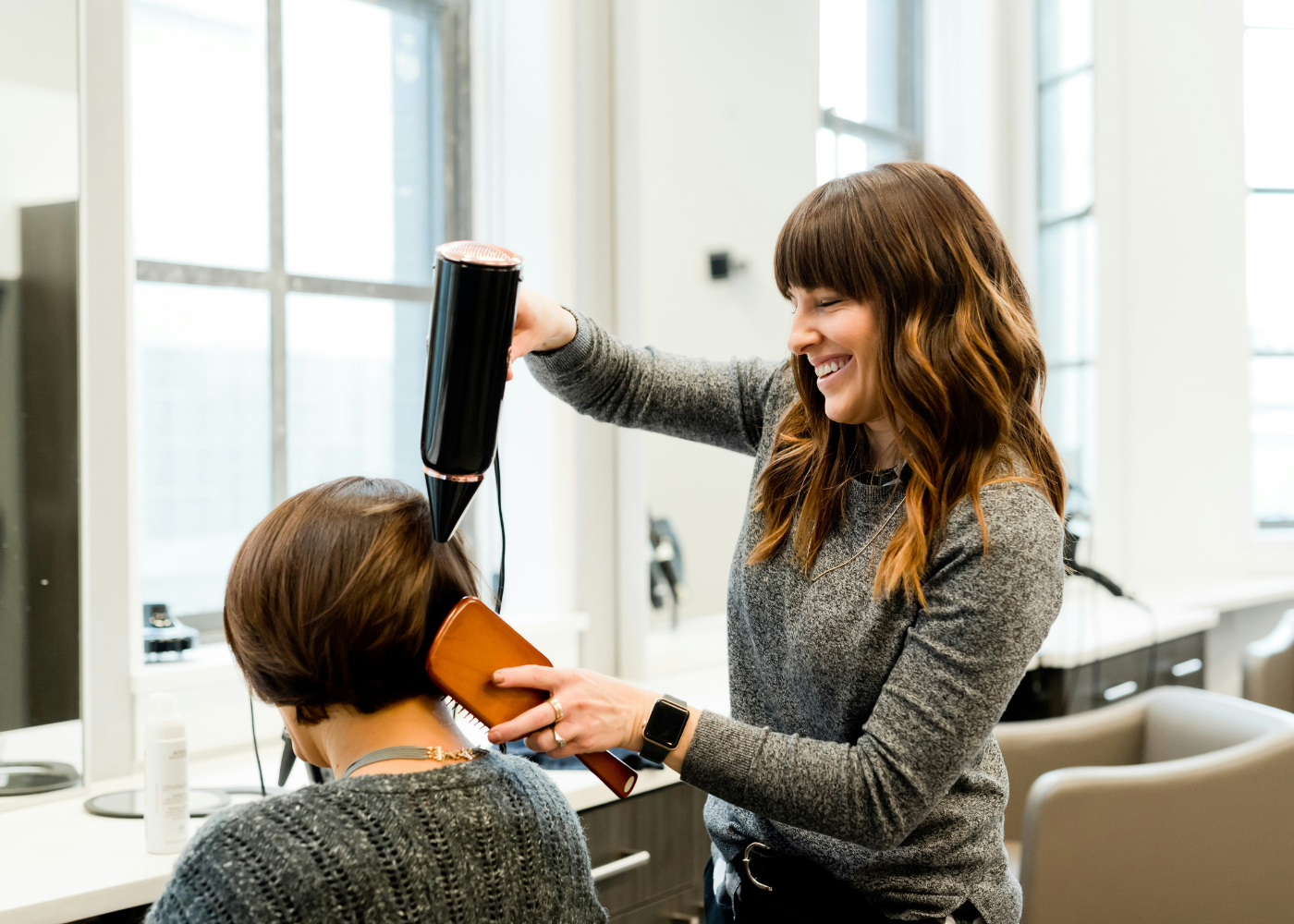 Best hair salons in Singapore - A hairstylist blow-drying a customer's hair