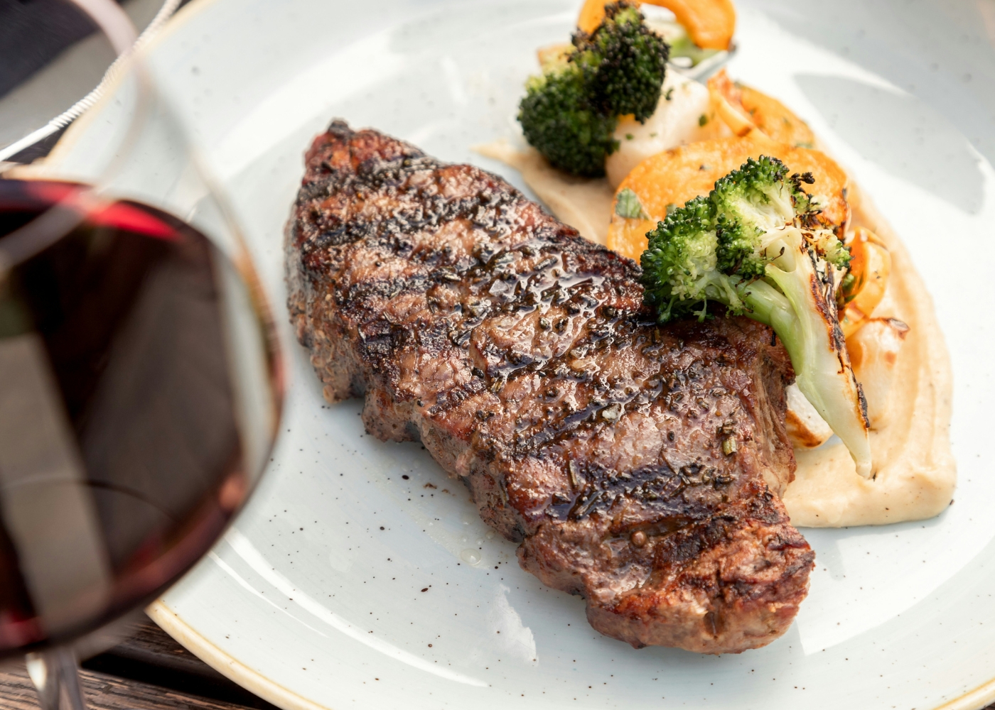 Best steak restaurants in Singapore - A close-up of a steak and a glass of wine