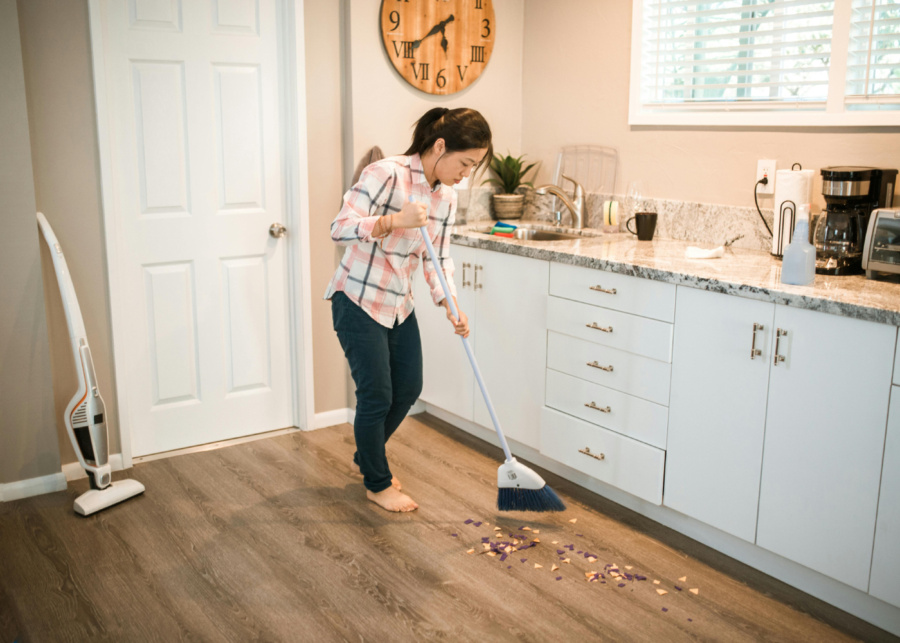Best spring cleaning services in Singapore - Asian woman sweeping the floor