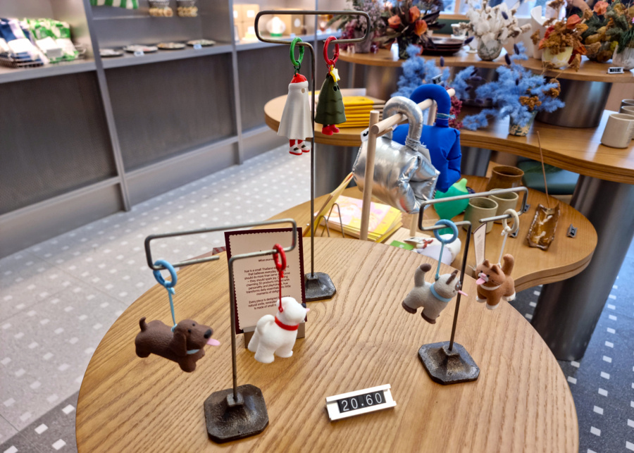 Curated lifestyle products like bag charms, cup holders, preserved floral arrangements, and pottery pieces | Crumb & Go