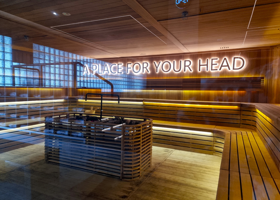 Dry sauna with A Place For Your Head neon sign | Shelter by ReFormd