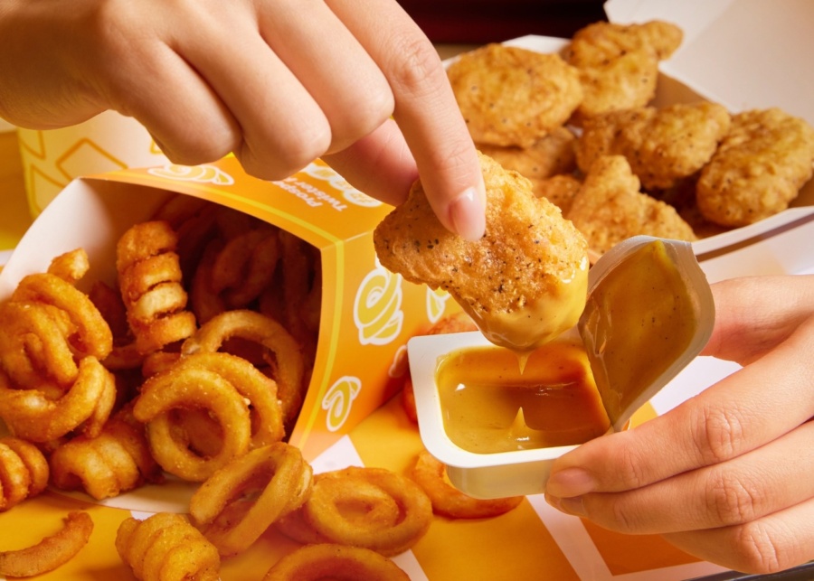 McDonald's chicken mcnugget dipped in curry sauce