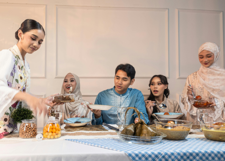 Host serving food to guests during Eid | Hari Raya traditions and visiting etiquette