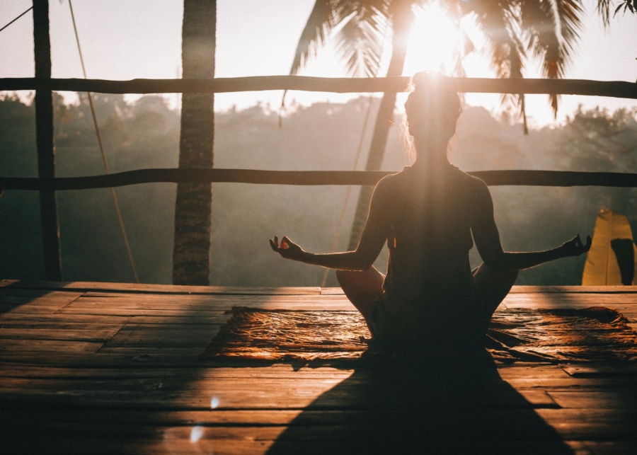 HoneyGlow Retreat in the CIty - Backview of a woman meditating during sunset