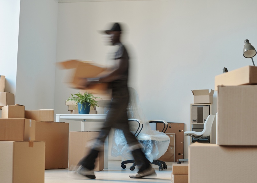 Best professional office movers in Singapore - A male staff moving boxes out of an office