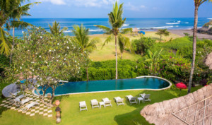 Check in to this authentic Balinese villa with private beach access and infinity pool near Canggu