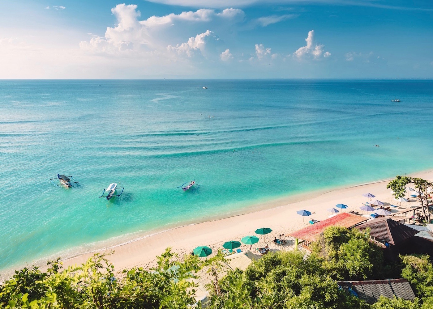 Bright blue sea and white sands of Thomas Beach in Uluwatu, Bali, Indonesia