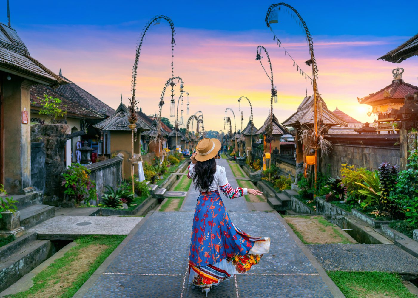 a picture of a female tourist strolling down to Penglipuran Village