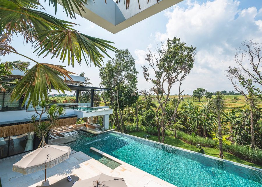 The infinity pool at Villa Nica overlooks rice paddies in Pererenan, Canggu, Bali.