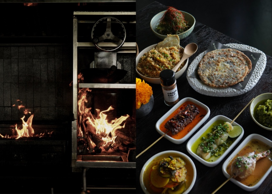 Kitchen with an open-flame grill and shared food at Waatu restaurant in Uluwatu, Bali, Indonesia