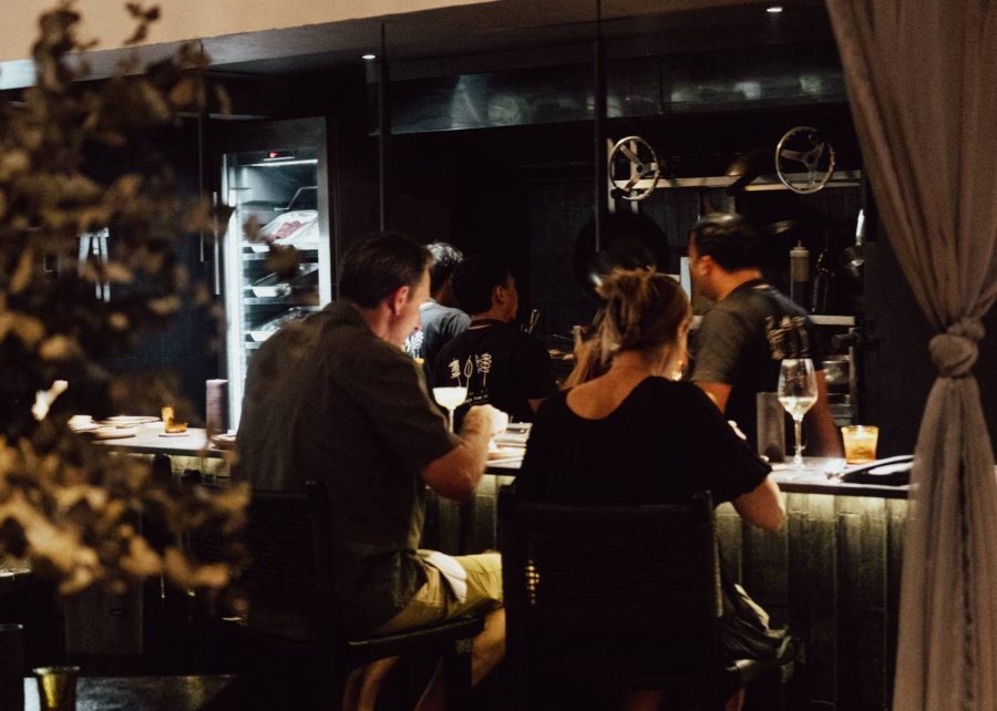 Couple eating at the counter in Waatu restaurant in Uluwatu, Bali, Indonesia