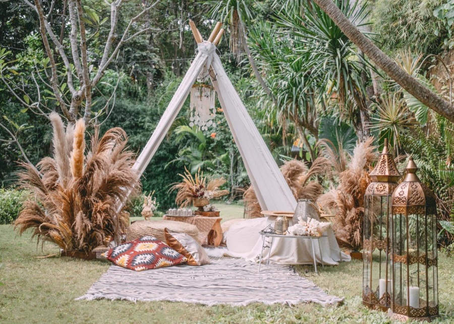 A tipi tent and a picnic set on a lawn by Bali Decor Rental - one of the best vendors for weddings in Bali Indonesia