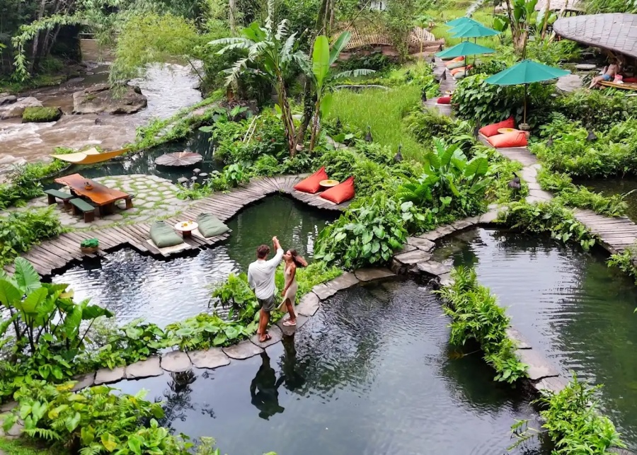 A couple enjoying a Day Pass and river club experience at Bambu Indah in Ubud, Bali, Indonesia