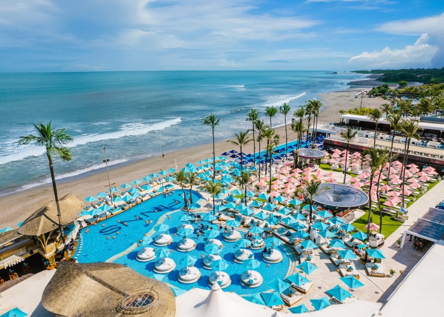 Drone shot of the beach and pools at FINNS Beach Club in Canggu, Bali, Indonesia