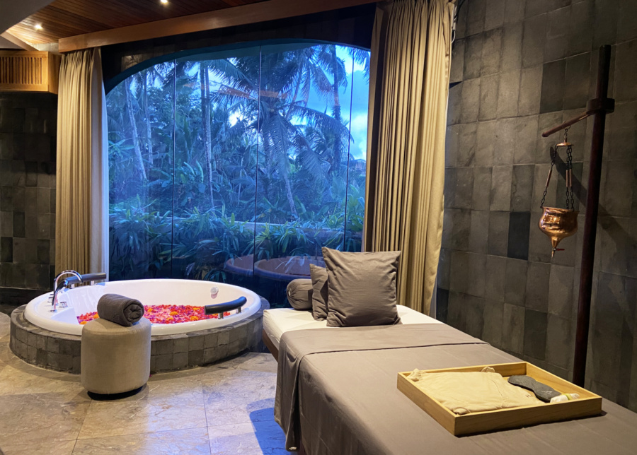 Couple's massage room with a flower bath overlooking rice paddies at Hammana Spa in Ubud, Bali, with romantic vibes