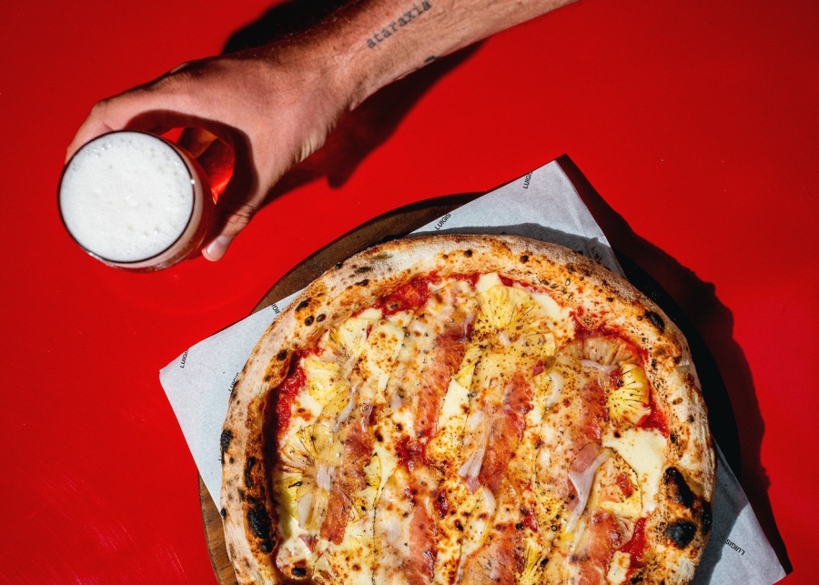 Pizza and beer from Luigi's italian restaurant in Canggu, Bali, Indonesia
