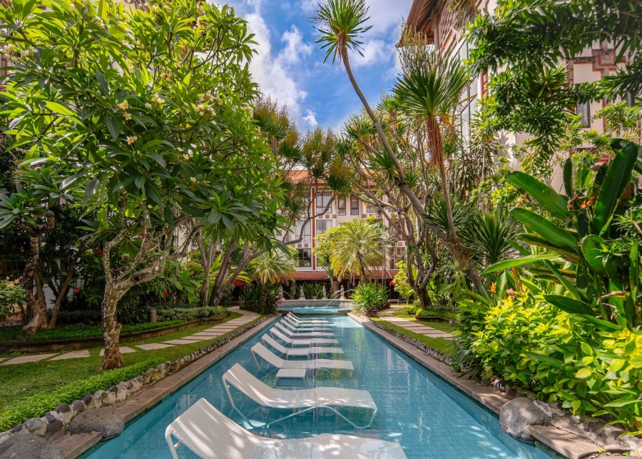 Sunbeds sitting in the pool at Prime Plaza Hotel Sanur in Bali, Indonesia