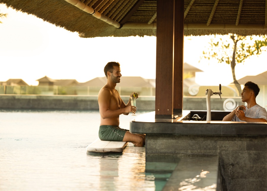 The swim-up bar on the rooftop at sunset, at Holiday Inn Resort Bali Canggu, with ocean views