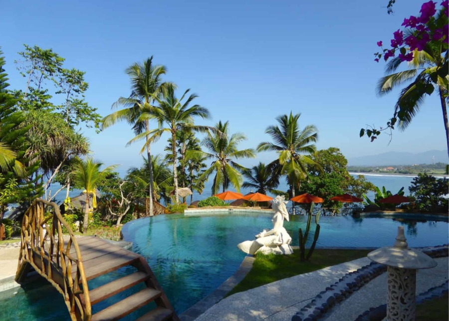Infinity pool overlooking the black-sand beach at Puri Dajuma Beach Eco-Resort in Pekutatan, West Bali.