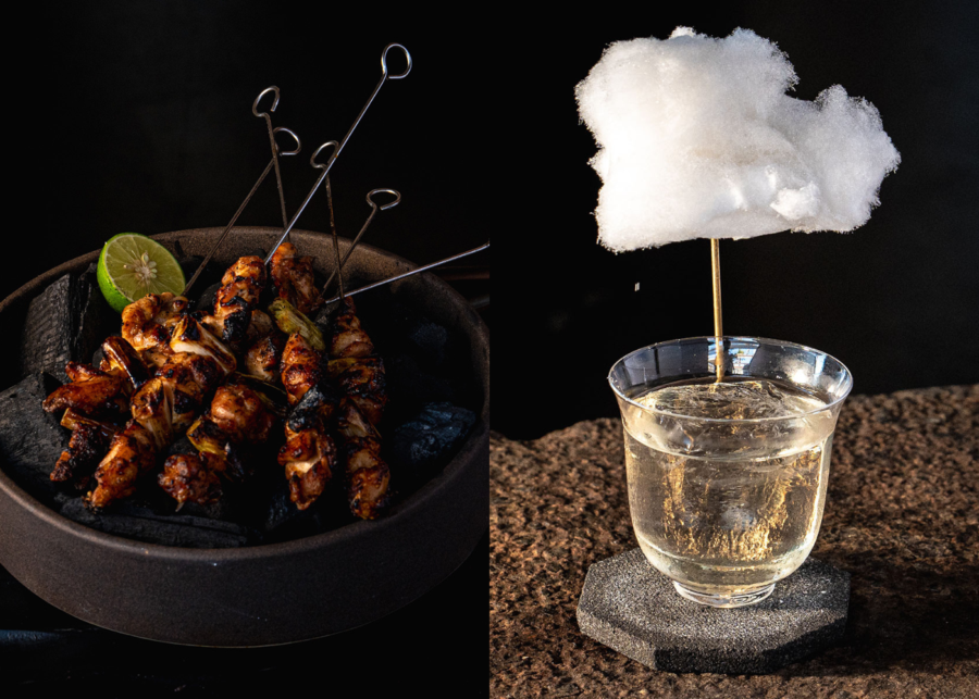 Close-up of Waatu’s chicken and leek yakitori grilled over coals, served with lime, alongside one of the bar’s signature cocktails topped with a cloud-like cotton candy garnish.