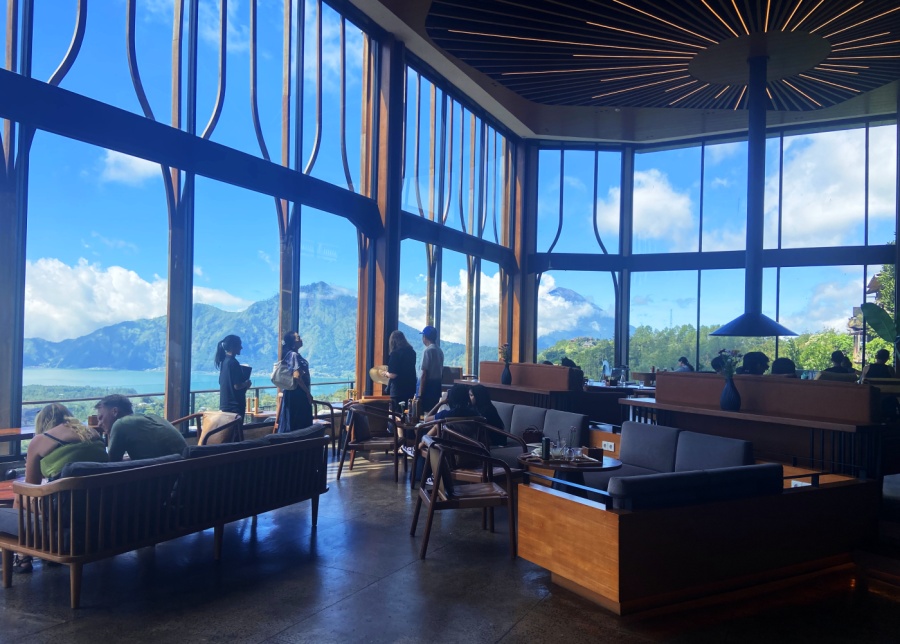 Interior at Pahdi Specialty Coffee, with floor-to-ceiling windows overlooking the mountains and lake in Kintamani, Bali, Indonesia