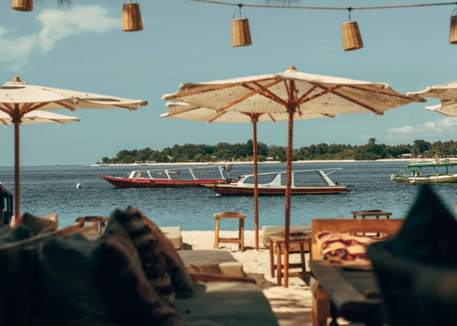 Beach seating on the sand by the ocean at La Cala Beach Club - one of the best places to eat in Gili Trawangan, Lombok, Indonesia