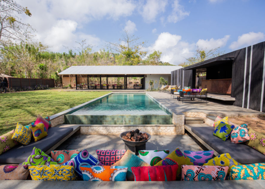 Private pool area at Origin Uluwatu featuring a minimalist villa design, sun loungers and a spacious garden setting in the Bukit peninsula.