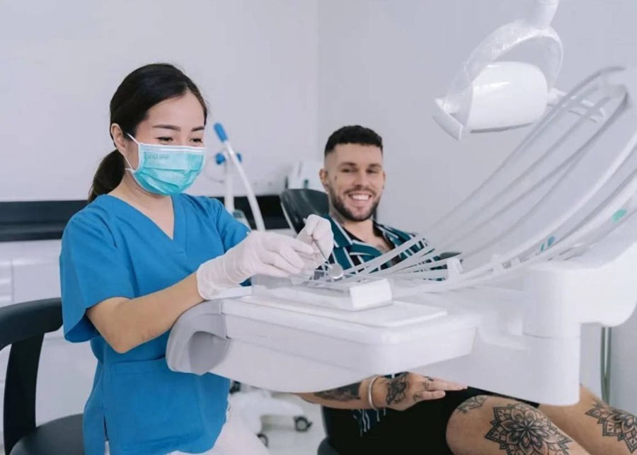 Hygienist preparing equipment tray for a dental procedure at ARC Dental Clinic in Kuta, Bali, Indonesia
