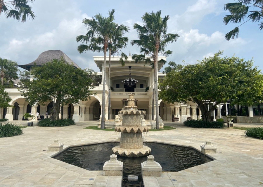 The main courtyard with a water fountain and palm trees inside Jumeirah Bali luxury hotel in Uluwatu