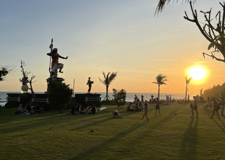 Children playing on the lawn at sunset at Thalassa Seseh near Canggu, Bali, Indonesia