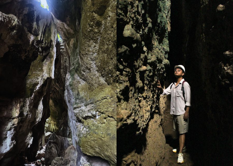 Interior of Goa Batu Cermin (Mirror Cave) in Labuan Bajo, showing tall limestone rock walls with natural light filtering from above, and a visitor walking carefully through the narrow cave passage.