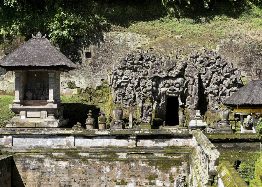 The popular entrance with stone carvings at Goa Gajah Temple near Ubud, Bali