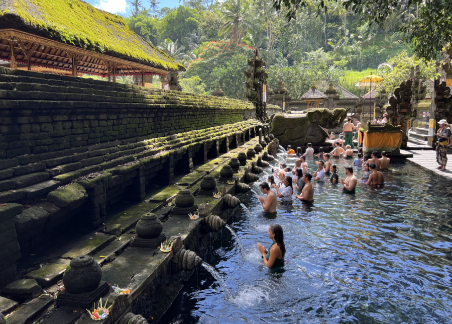 Melukat water purification ceremony at the holy spring pool at Tirtha Empul temple in Tampaksiring, near Ubud, Bali