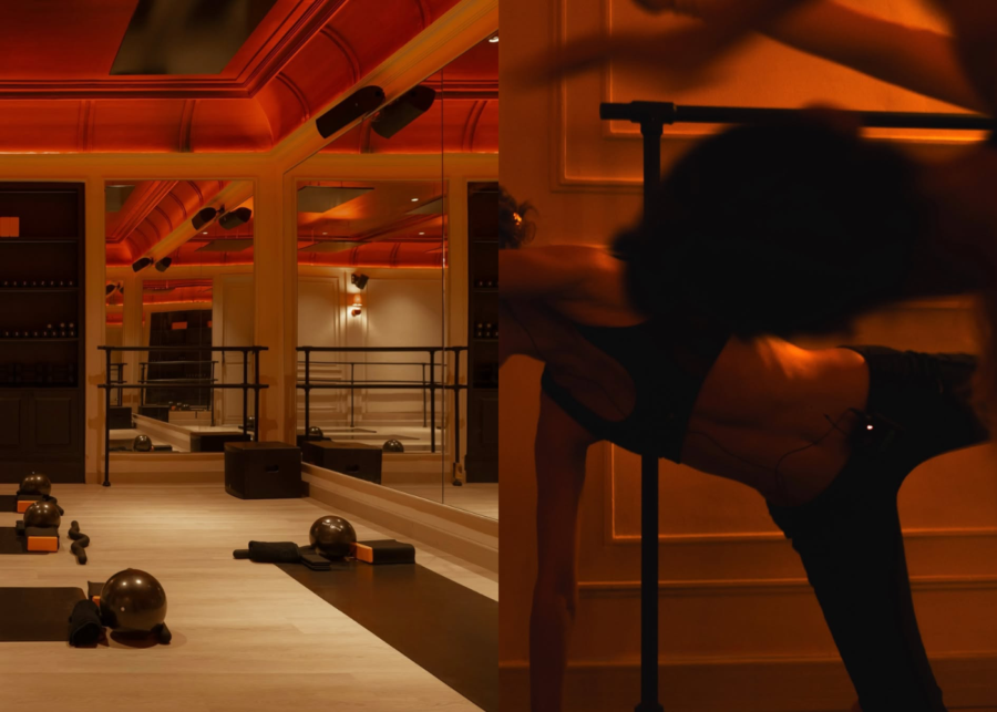 The infrared-lit studio at Heat House Uluwatu, with mirrored walls, a barre, Pilates balls and mats, and a person stretching in the warm glow.
