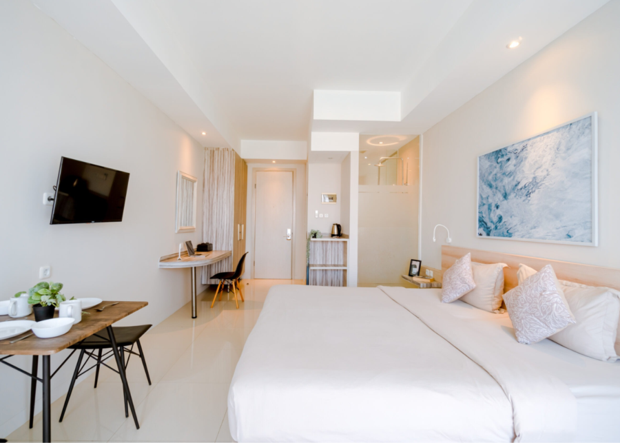 A private room at Bali Bustle, a coliving space in Bali with a queen bed, work desk and air conditioning.