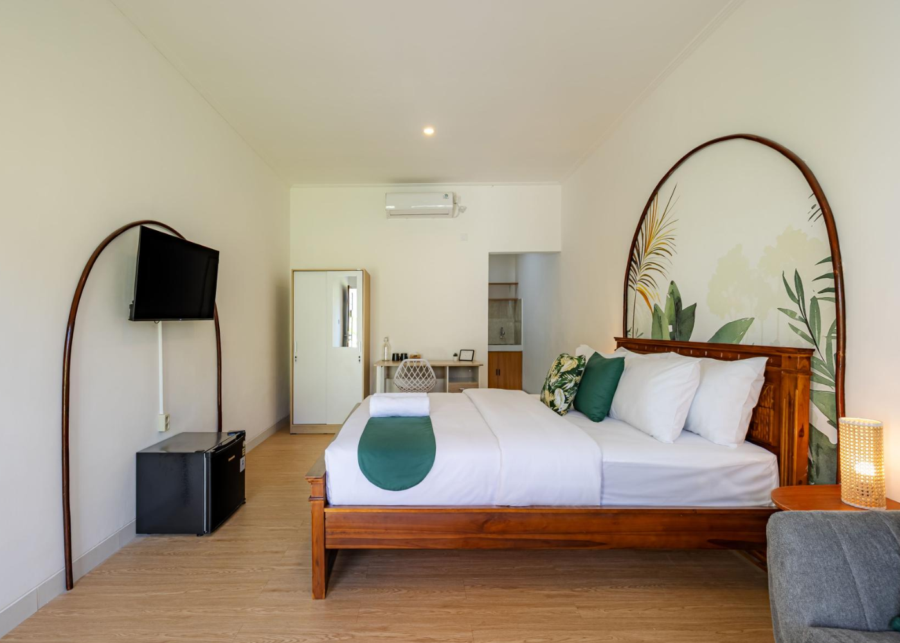 A private room at a Cove coliving space in Bali with a double bed, work desk and air conditioning.